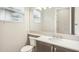 Bright bathroom featuring large mirror, sink, and toilet at 4838 Sevilla Shores Dr, Wimauma, FL 33598