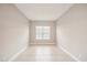 An empty bedroom shows the neutral colors and bright natural light from the window at 4838 Sevilla Shores Dr, Wimauma, FL 33598