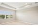 Bright bedroom with recessed ceilings and bright window view at 4838 Sevilla Shores Dr, Wimauma, FL 33598