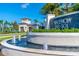 Elegant Valencia Del Sol community entrance with water feature and lush landscaping at 4838 Sevilla Shores Dr, Wimauma, FL 33598