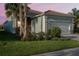 Charming single-Gathering home with a well-manicured lawn, colorful plants and a two-car garage at 4838 Sevilla Shores Dr, Wimauma, FL 33598