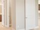Bright hallway featuring neutral paint, white trim, and doors with views to bathroom and closet at 4838 Sevilla Shores Dr, Wimauma, FL 33598