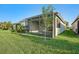 A spacious screened lanai and illuminated backyard create a relaxing outdoor retreat at 4838 Sevilla Shores Dr, Wimauma, FL 33598