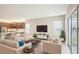 Spacious living room features an open floorplan to the kitchen with natural light and modern decor at 4838 Sevilla Shores Dr, Wimauma, FL 33598