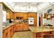 Galley kitchen with wood cabinets and granite countertop at 731 E Lumsden Rd, Brandon, FL 33511