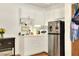 Small kitchen with white cabinets and stainless steel fridge at 731 E Lumsden Rd, Brandon, FL 33511