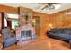 Living room with brick fireplace and wood paneling at 731 E Lumsden Rd, Brandon, FL 33511