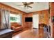 Cozy living room with wood paneling and a fireplace at 731 E Lumsden Rd, Brandon, FL 33511