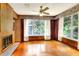 Living room with wood walls, hardwood floors, and a fireplace at 731 E Lumsden Rd, Brandon, FL 33511