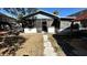 View of the backyard with a screened-in porch and weathered walkway leading up to the house at 6138 Island Dr, Weeki Wachee, FL 34607
