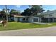 Cozy single-story home featuring a screen garage, and a well-maintained lawn at 6138 Island Dr, Weeki Wachee, FL 34607