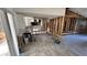 Kitchen area under construction with white cabinets, stainless steel sink, and wood-look flooring at 6138 Island Dr, Weeki Wachee, FL 34607