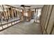 Open-concept living room under construction featuring exposed framing and wood-look flooring with fan at 6138 Island Dr, Weeki Wachee, FL 34607