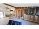 Open-concept living room under construction featuring exposed framing and wood-look flooring at 6138 Island Dr, Weeki Wachee, FL 34607