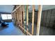 Living room under construction with exposed framing, a large window, and wood-look flooring at 6138 Island Dr, Weeki Wachee, FL 34607