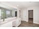 Bathroom featuring double vanity, sleek fixtures, and a separate area with a shower and free-standing tub at 10288 Surrey Rose Dr, San Antonio, FL 33576