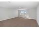 Well-lit bedroom boasting two windows and soft carpeting, ensuring maximum comfort and style at 10288 Surrey Rose Dr, San Antonio, FL 33576