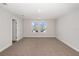 Bright bedroom featuring plush carpeting, recessed lighting, and a double window for natural light at 10288 Surrey Rose Dr, San Antonio, FL 33576