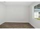 A bright bedroom with stylish laminate flooring and a window offering natural light at 10288 Surrey Rose Dr, San Antonio, FL 33576