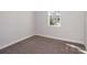 A cozy carpeted bedroom with a large window and ample natural light at 10288 Surrey Rose Dr, San Antonio, FL 33576
