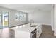 Open-concept kitchen with a large island and stainless steel appliances, flowing into the living area at 10288 Surrey Rose Dr, San Antonio, FL 33576