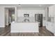 Bright kitchen featuring white cabinets, stainless steel appliances, and a large island at 10288 Surrey Rose Dr, San Antonio, FL 33576