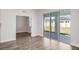 Bright living room with sliding glass doors leading to the backyard and wood-look floors at 10288 Surrey Rose Dr, San Antonio, FL 33576