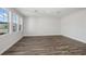A spacious living room is filled with natural light and features elegant wood flooring, creating a warm ambiance at 10288 Surrey Rose Dr, San Antonio, FL 33576