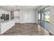 Spacious room with wood floors, white walls, and sliding glass doors with backyard view at 10288 Surrey Rose Dr, San Antonio, FL 33576