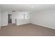 Expansive loft area providing flexible living space with cozy carpeting and natural light at 10288 Surrey Rose Dr, San Antonio, FL 33576
