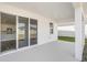 Covered outdoor patio with views of the backyard, accessible from the interior at 10288 Surrey Rose Dr, San Antonio, FL 33576