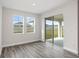 Bright dining room with hardwood floors and sliding glass doors to backyard at 10317 Fieldstone Myrtle Way, San Antonio, FL 33576