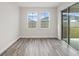 Bright dining room with hardwood floors and sliding glass doors to backyard at 10317 Fieldstone Myrtle Way, San Antonio, FL 33576