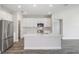 Modern kitchen with white cabinets, stainless steel appliances, and a large island at 10317 Fieldstone Myrtle Way, San Antonio, FL 33576