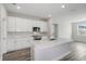 Modern kitchen with white cabinets, stainless steel appliances, and a large island at 10317 Fieldstone Myrtle Way, San Antonio, FL 33576