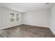 Bright and airy living room featuring hardwood floors and large windows at 10317 Fieldstone Myrtle Way, San Antonio, FL 33576