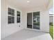 Covered patio with sliding glass door access to the interior at 10317 Fieldstone Myrtle Way, San Antonio, FL 33576