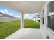 Covered patio overlooking a grassy backyard with privacy fence at 10317 Fieldstone Myrtle Way, San Antonio, FL 33576