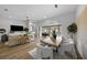 Bright dining area with a wood table and chairs, overlooking the pool area at 9120 Warm Springs Cir, Parrish, FL 34219