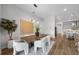 Open concept dining room with kitchen view and wood floors at 9120 Warm Springs Cir, Parrish, FL 34219