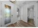 Inviting entryway with decorative glass door, leading to bedroom and bathroom at 9120 Warm Springs Cir, Parrish, FL 34219