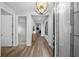 Bright and spacious entryway with wood floors and a stylish light fixture at 9120 Warm Springs Cir, Parrish, FL 34219