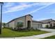 Charming single-story home with stone accents, three-car garage, and well-manicured lawn at 9120 Warm Springs Cir, Parrish, FL 34219