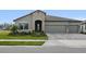 Beautiful single-story home with a three-car garage, stone accents, and well-manicured landscaping at 9120 Warm Springs Cir, Parrish, FL 34219