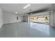 Spacious three car garage features epoxy flooring, and an automatic door at 9120 Warm Springs Cir, Parrish, FL 34219