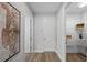 Bright hallway featuring wood-look flooring, leading to a storage closet and other rooms at 9120 Warm Springs Cir, Parrish, FL 34219