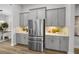 Contemporary kitchen showcasing stainless steel refrigerator, and bar with tile backsplash at 9120 Warm Springs Cir, Parrish, FL 34219