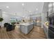 Modern kitchen with gray cabinetry, stainless steel appliances, and an island at 9120 Warm Springs Cir, Parrish, FL 34219