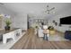 Spacious open-concept living room area with hardwood floors and modern lighting at 9120 Warm Springs Cir, Parrish, FL 34219