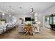 Bright living room features wood floors, modern decor, and sliding glass doors to the outdoor area at 9120 Warm Springs Cir, Parrish, FL 34219